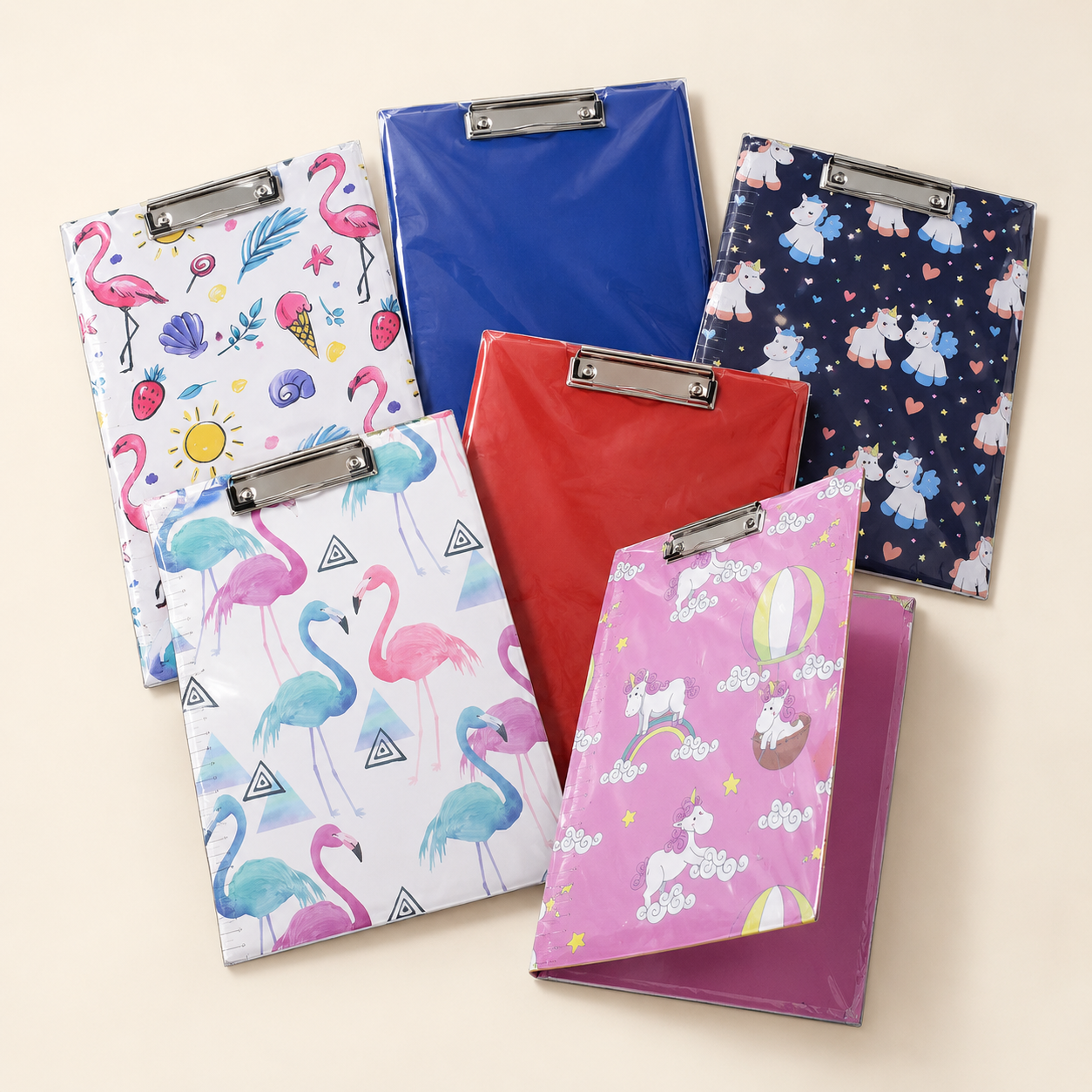 BioCode A4 stationery clipboards featuring assorted colourful designs including flamingos, unicorns, and solid colours.