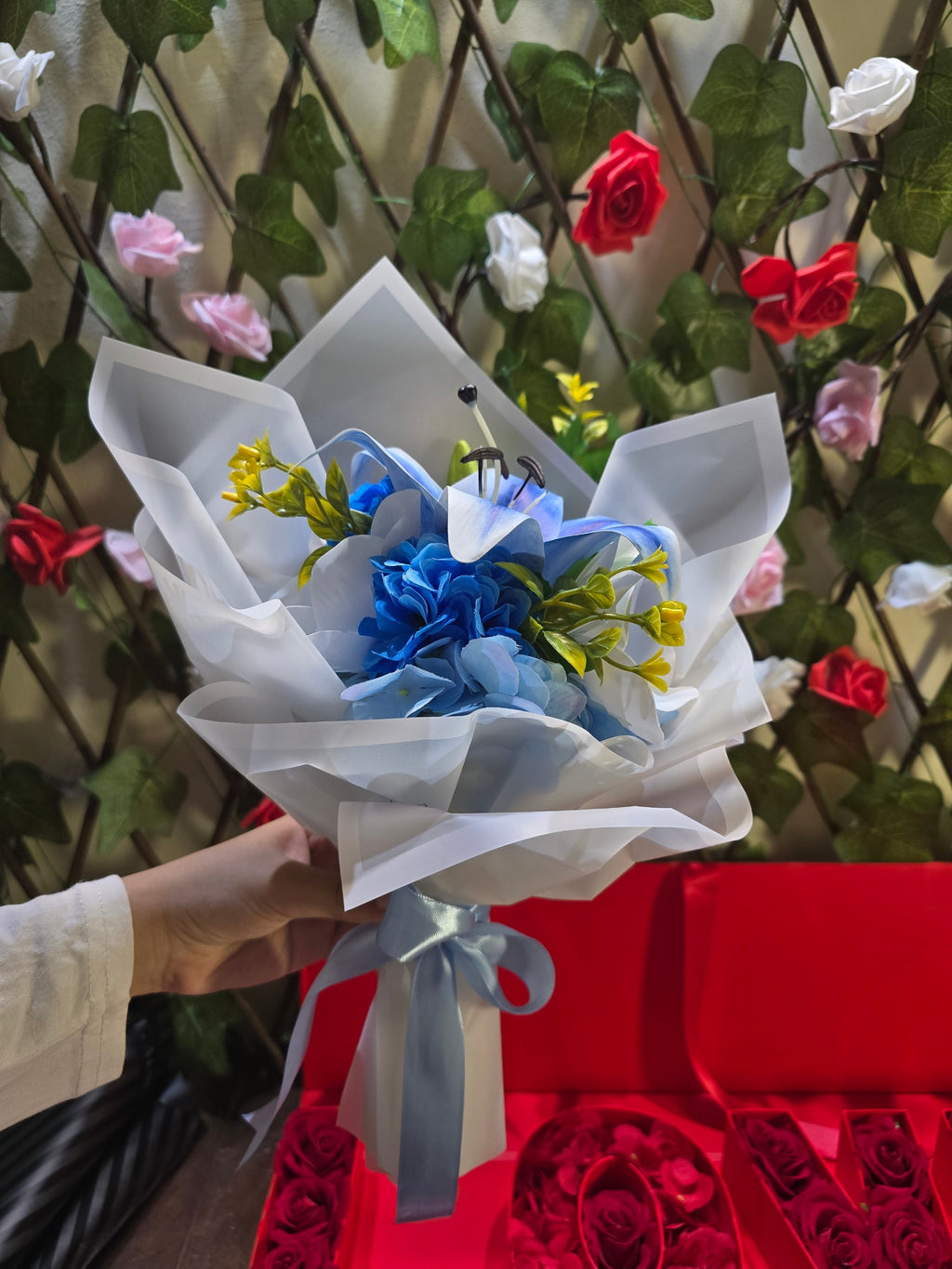 BioCode handcrafted artificial blue lily and hydrangea bouquet wrapped in premium white paper with a blue ribbon