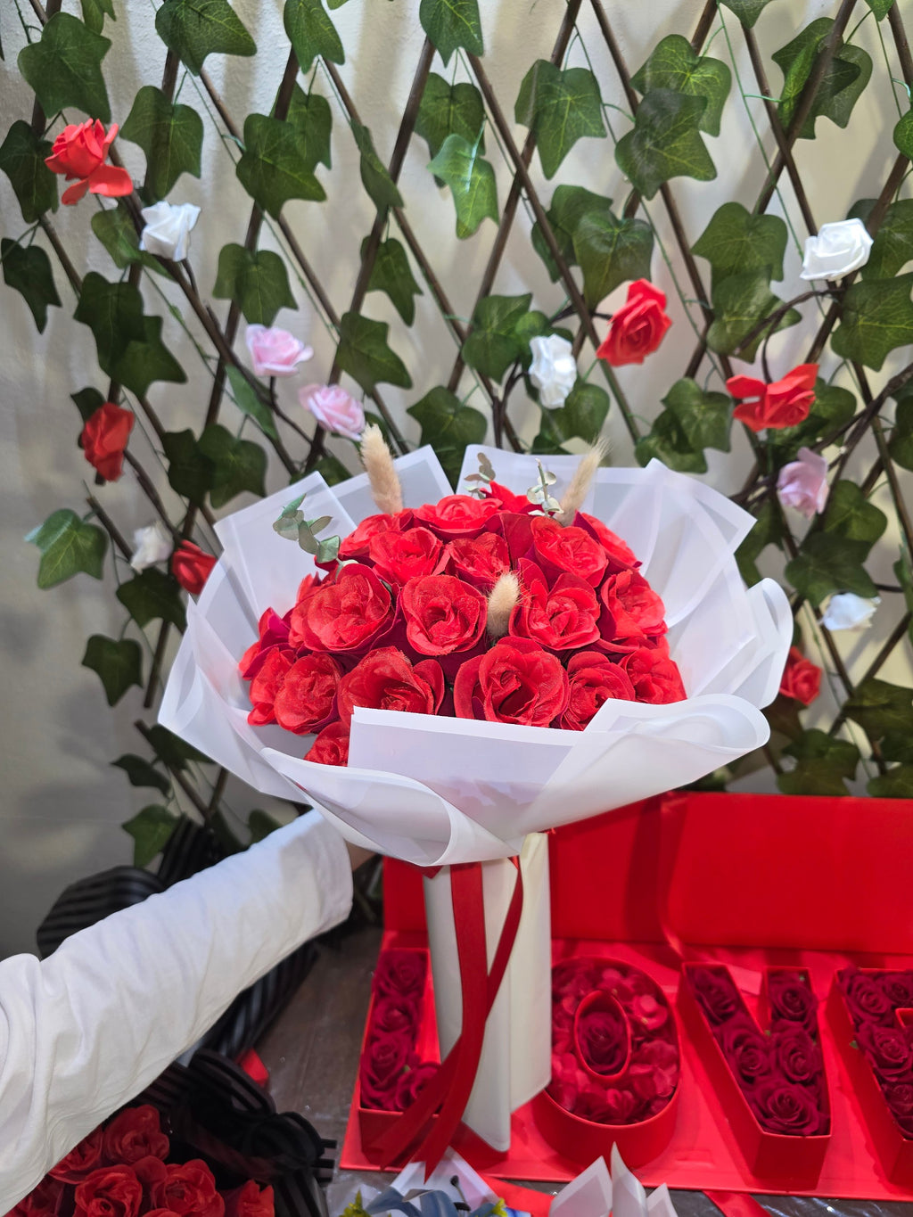 BioCode handcrafted artificial red rose bouquet wrapped in white paper with a red ribbon for romantic occasions