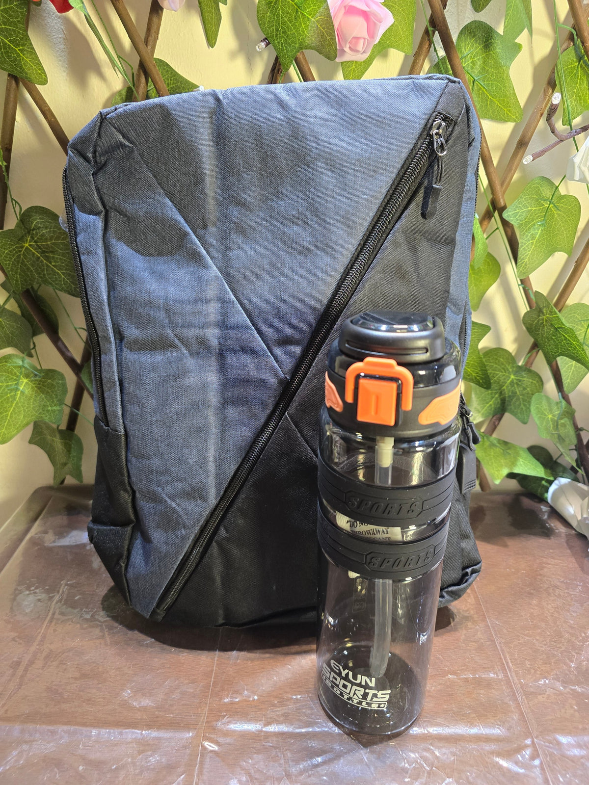 BioCode grey and black water-resistant backpack with a matching BPA-free sports water bottle with a locking lid.