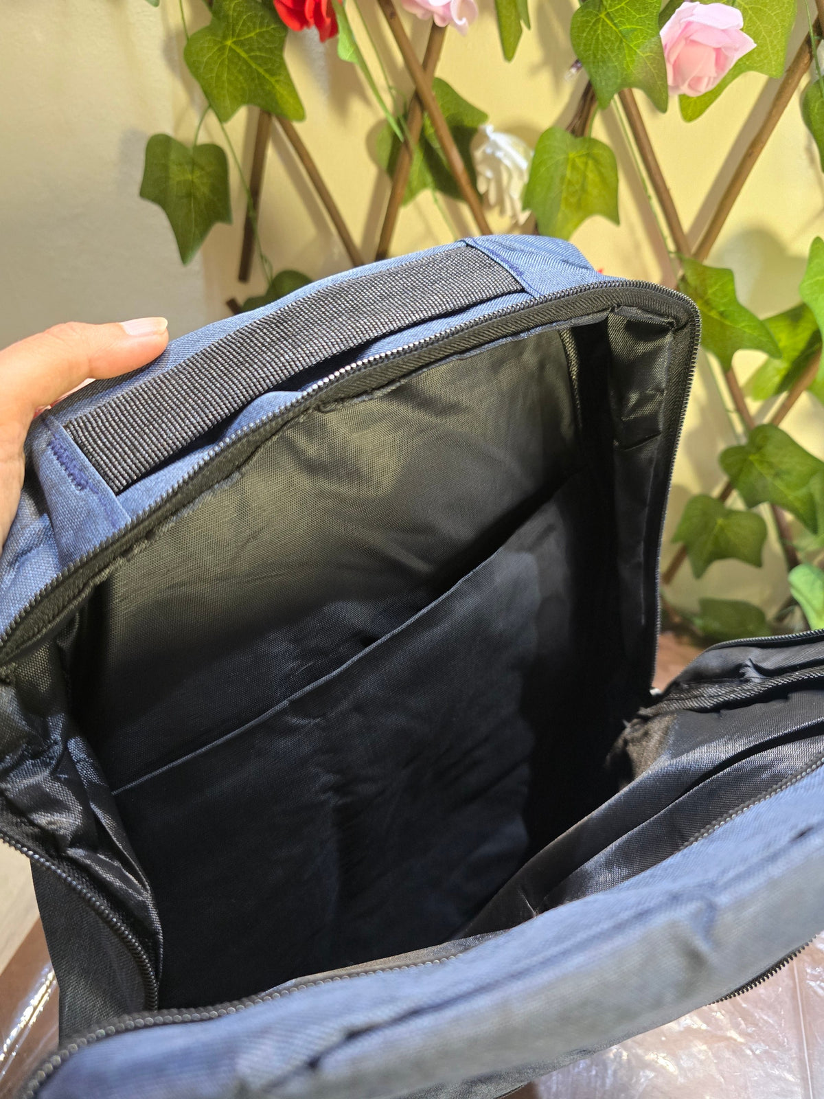 BioCode backpack interior showing a padded laptop compartment and organiser pockets in durable blue fabric