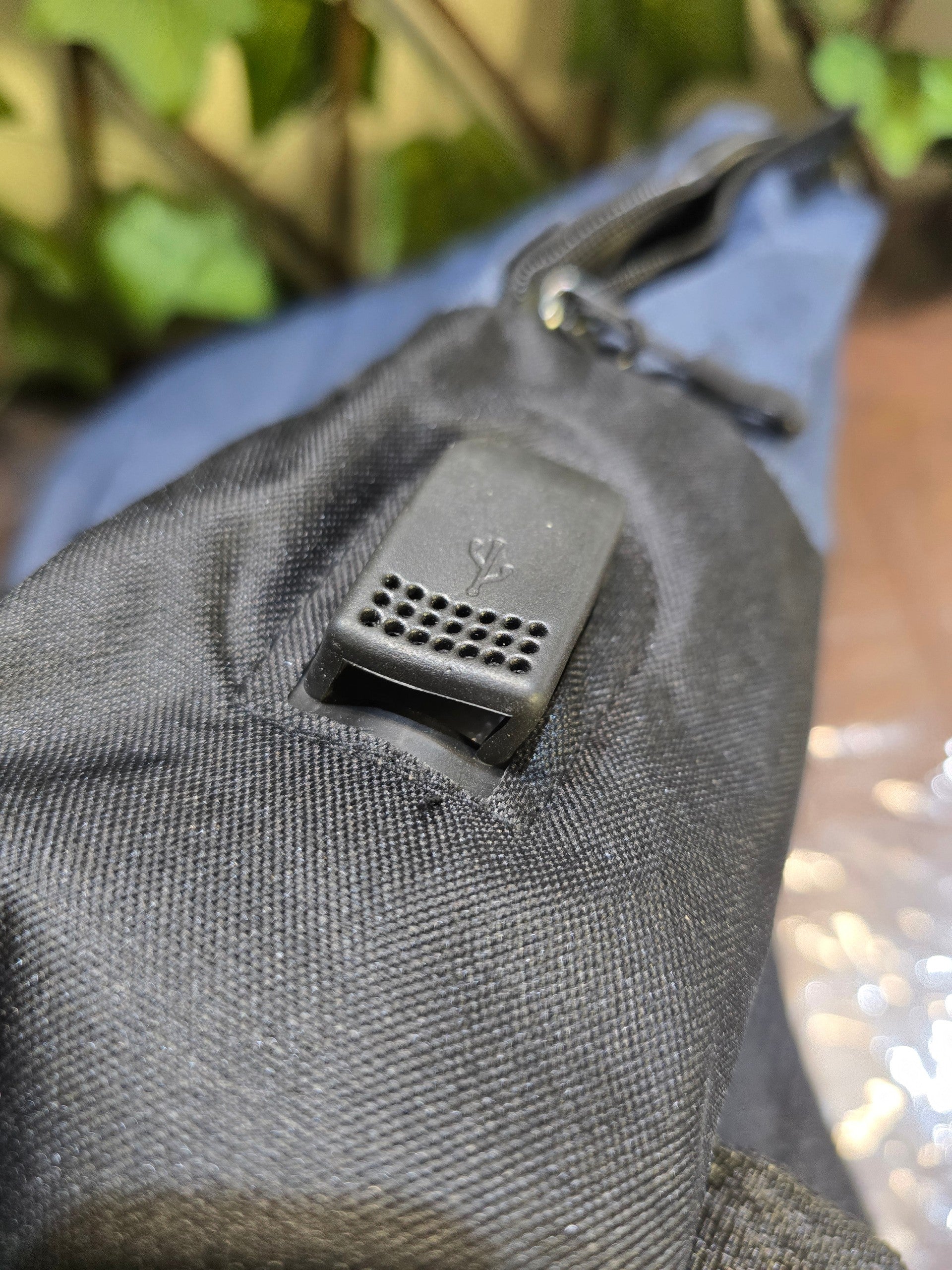BioCode backpack featuring a black water-resistant fabric exterior with an integrated external USB charging port