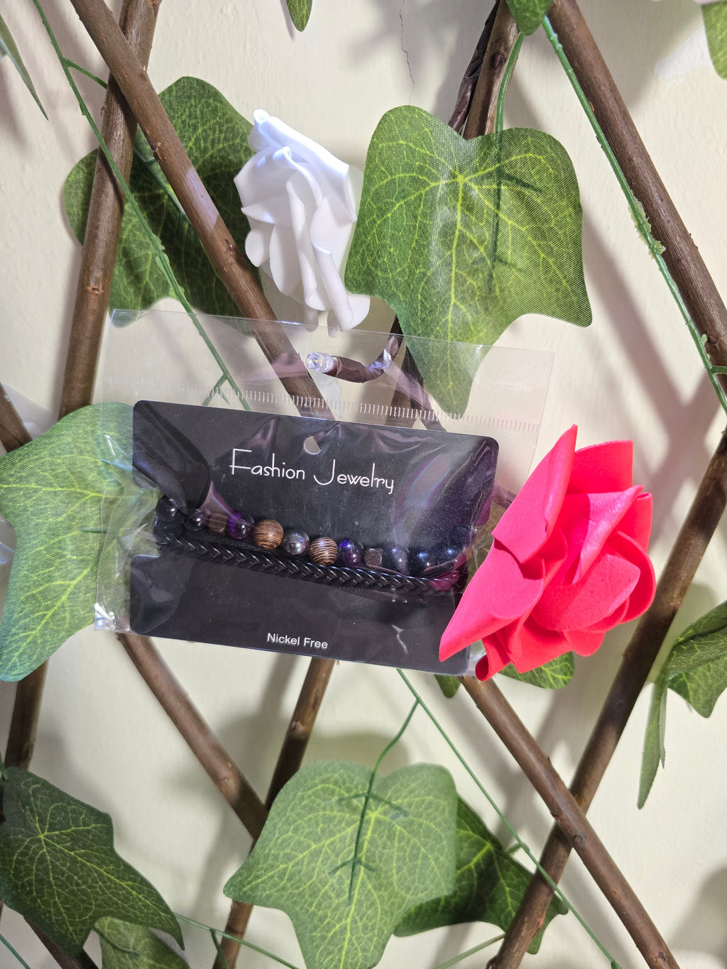 BioCode nickel-free beaded bracelet on a display card, featuring dark wooden and metallic beads with a braided band.