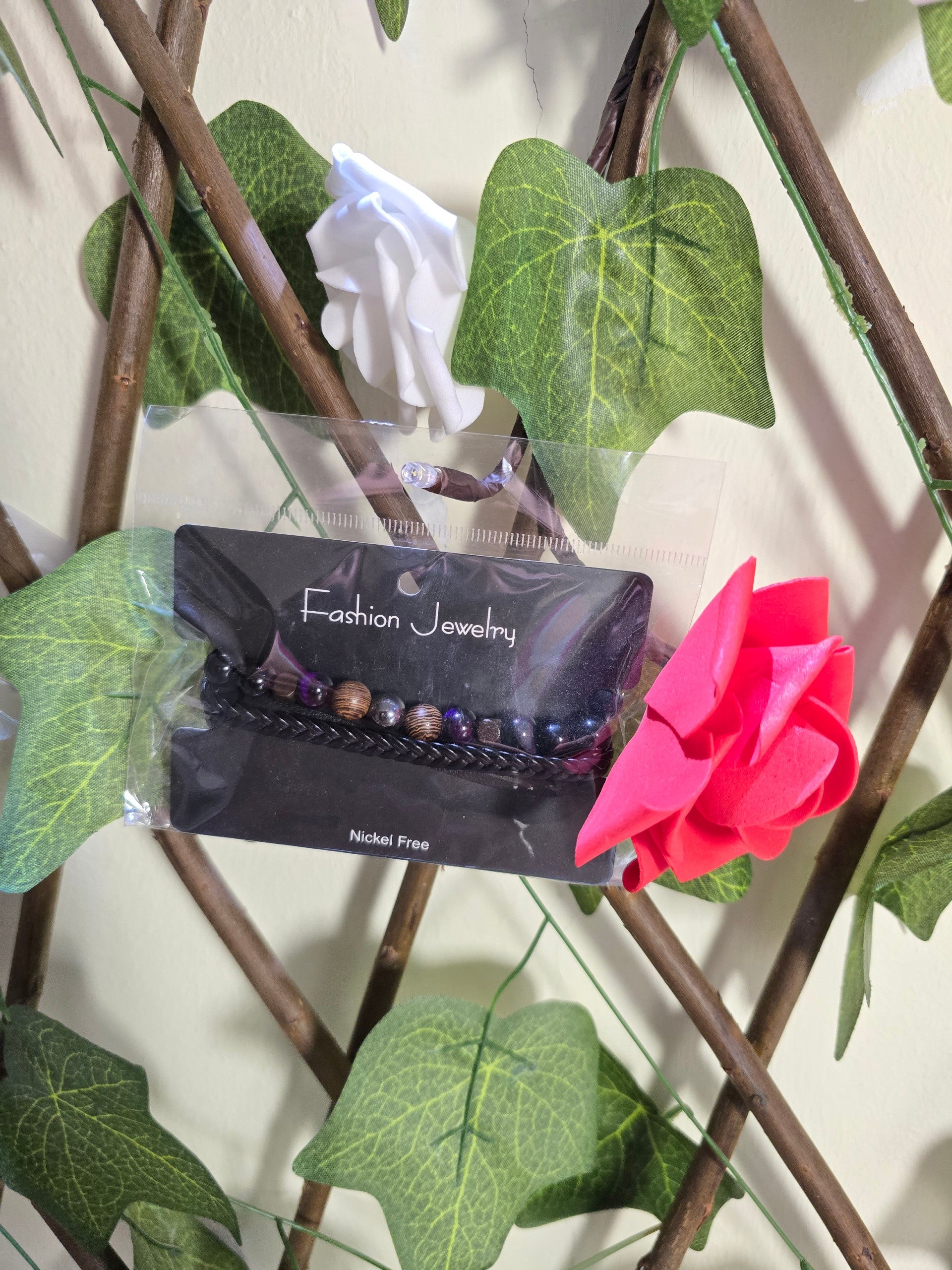 BioCode nickel-free beaded bracelet on a display card, featuring dark wooden and metallic beads with a braided band.