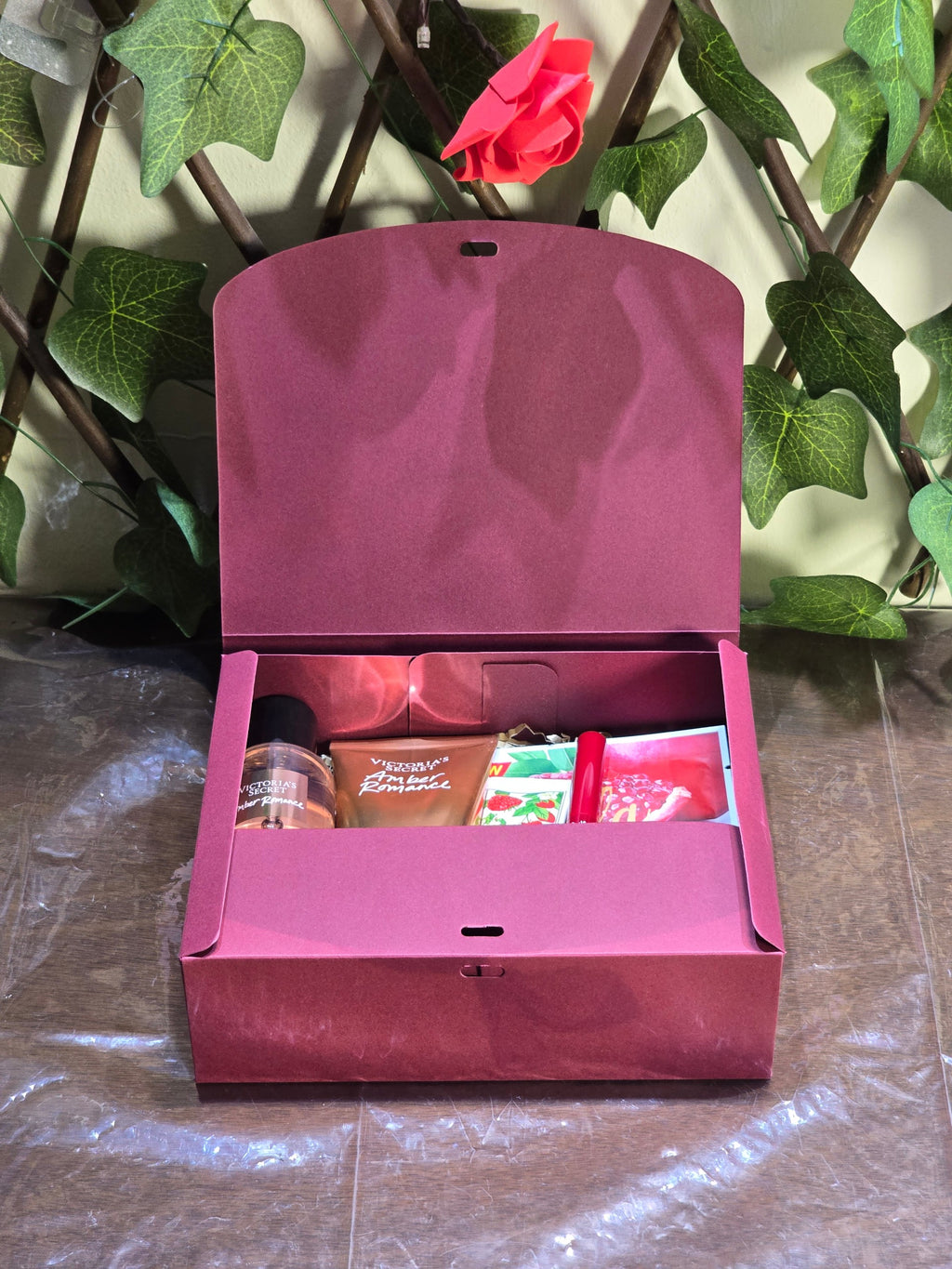 BioCode beauty gift set in a burgundy box containing Victoria's Secret fragrance, hand cream, and facial mask.