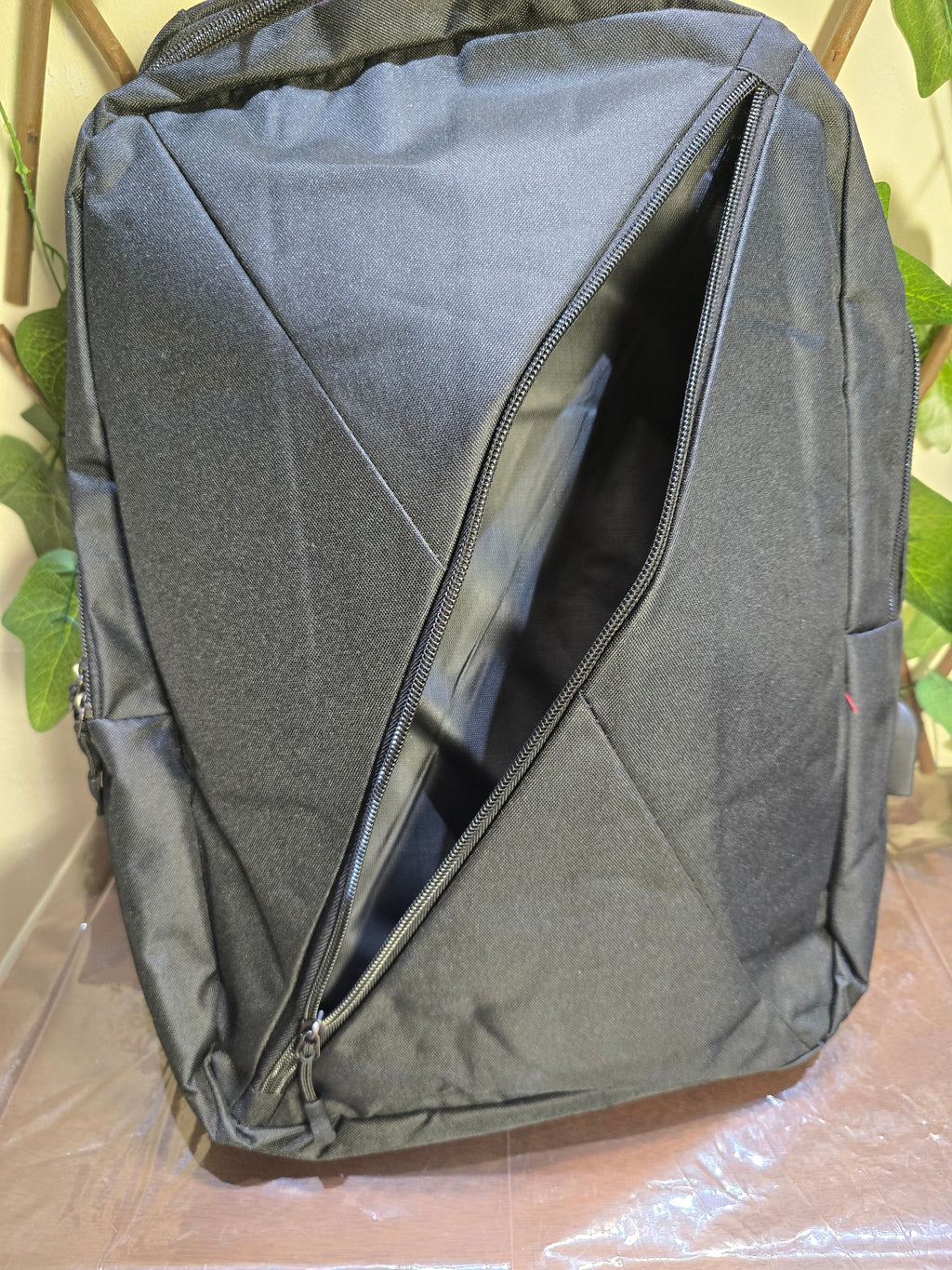 BioCode black minimalist commuter laptop backpack with a unique diagonal front zip pocket and durable fabric.