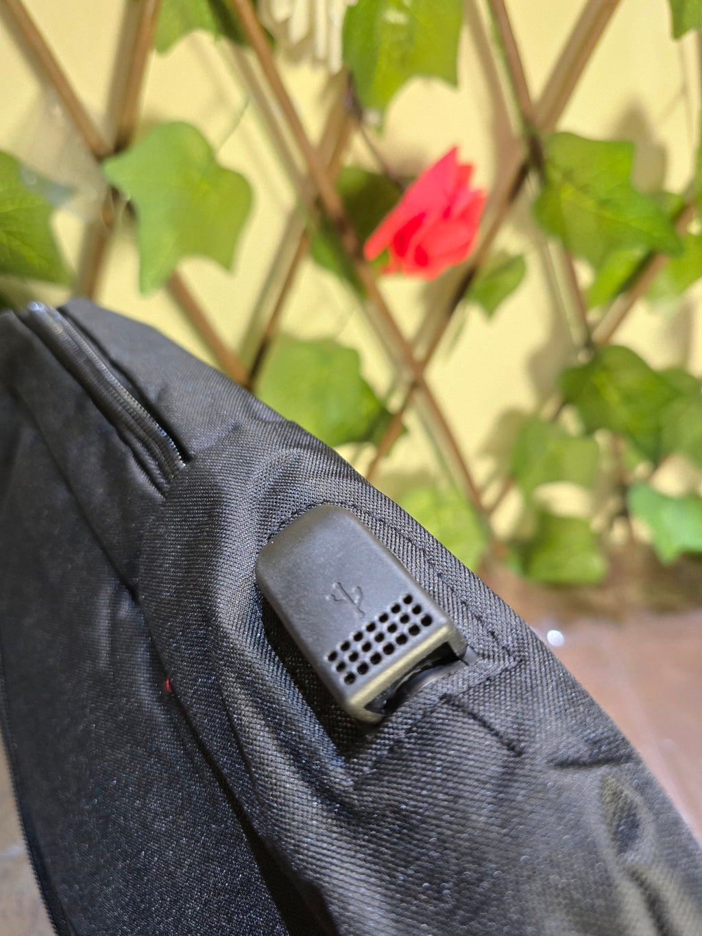 BioCode black minimalist commuter laptop backpack featuring an integrated external USB charging port