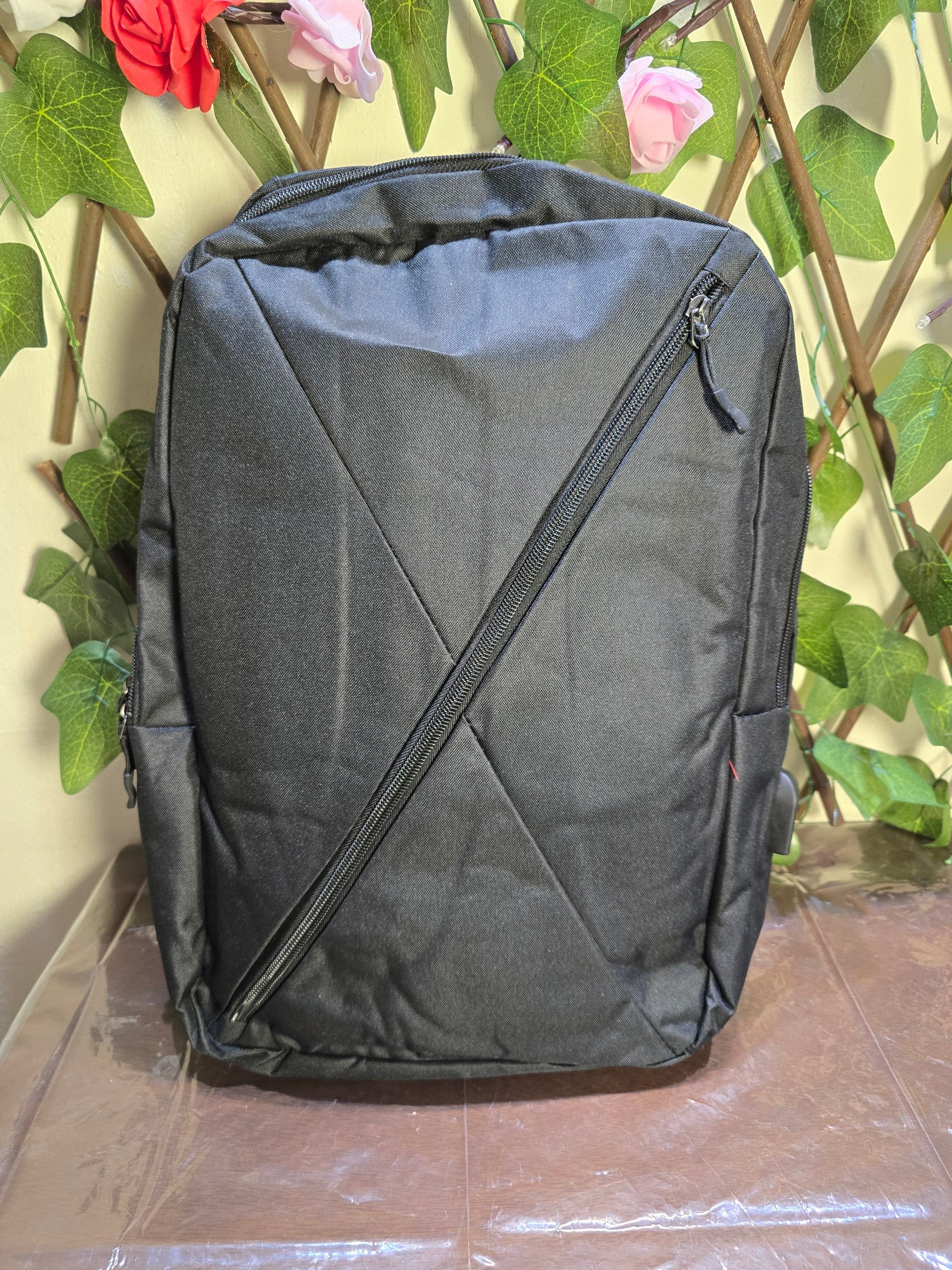 BioCode black minimalist commuter backpack with a diagonal front zip pocket and durable water-resistant fabric