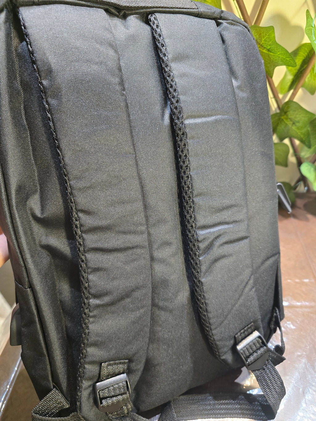 BioCode black water-resistant backpack featuring ergonomic padded shoulder straps and adjustable buckles