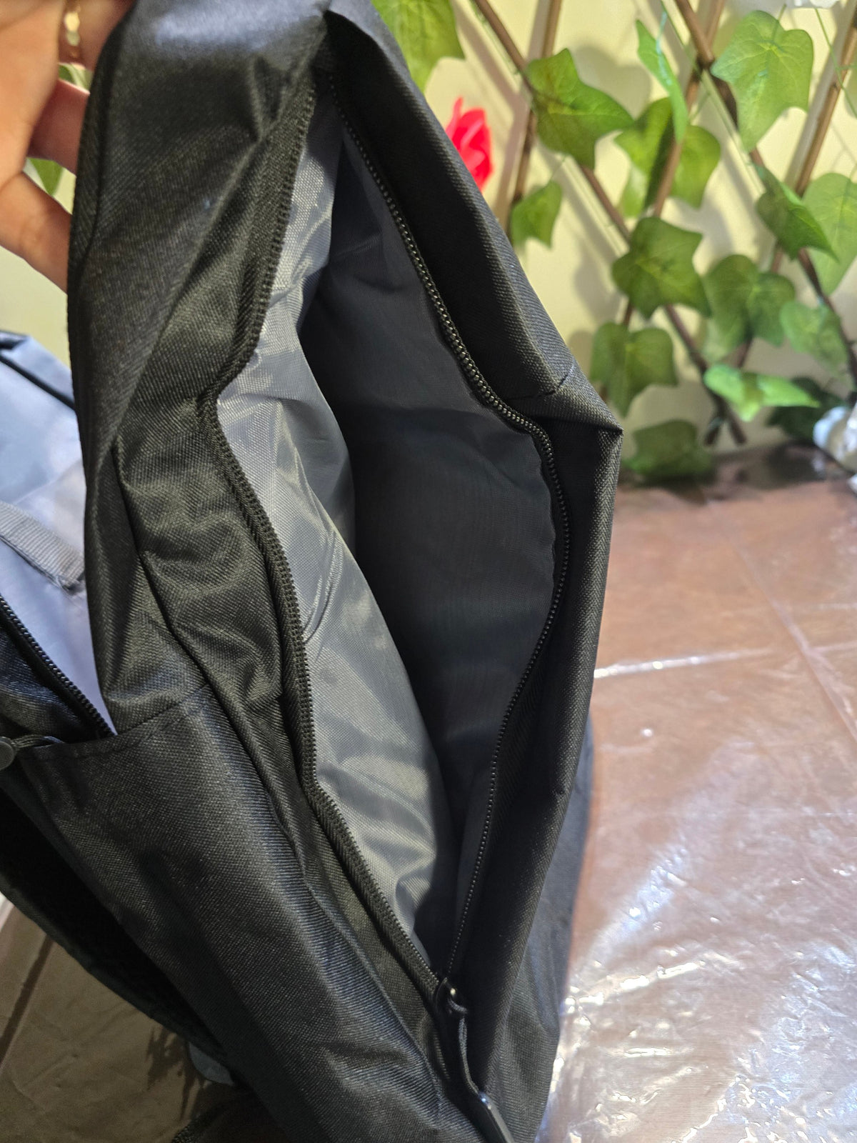 BioCode black water-resistant backpack showing the spacious interior compartment with a secure zip closure