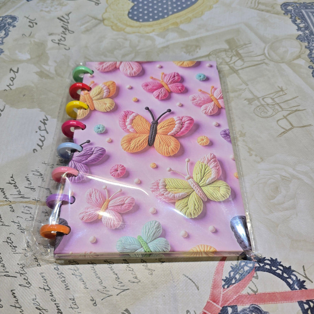 BioCode pastel pink disc-bound notebook with embossed 3D butterfly pattern and colourful plastic binding rings