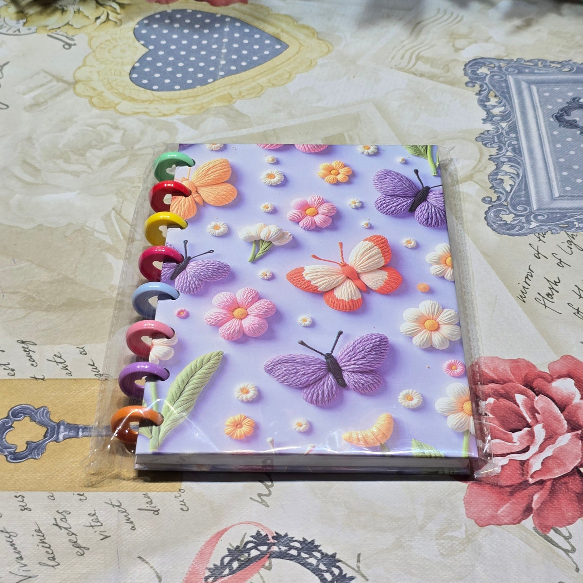 BioCode discbound notebook with a 3D-effect butterfly and floral print and colourful rainbow discs