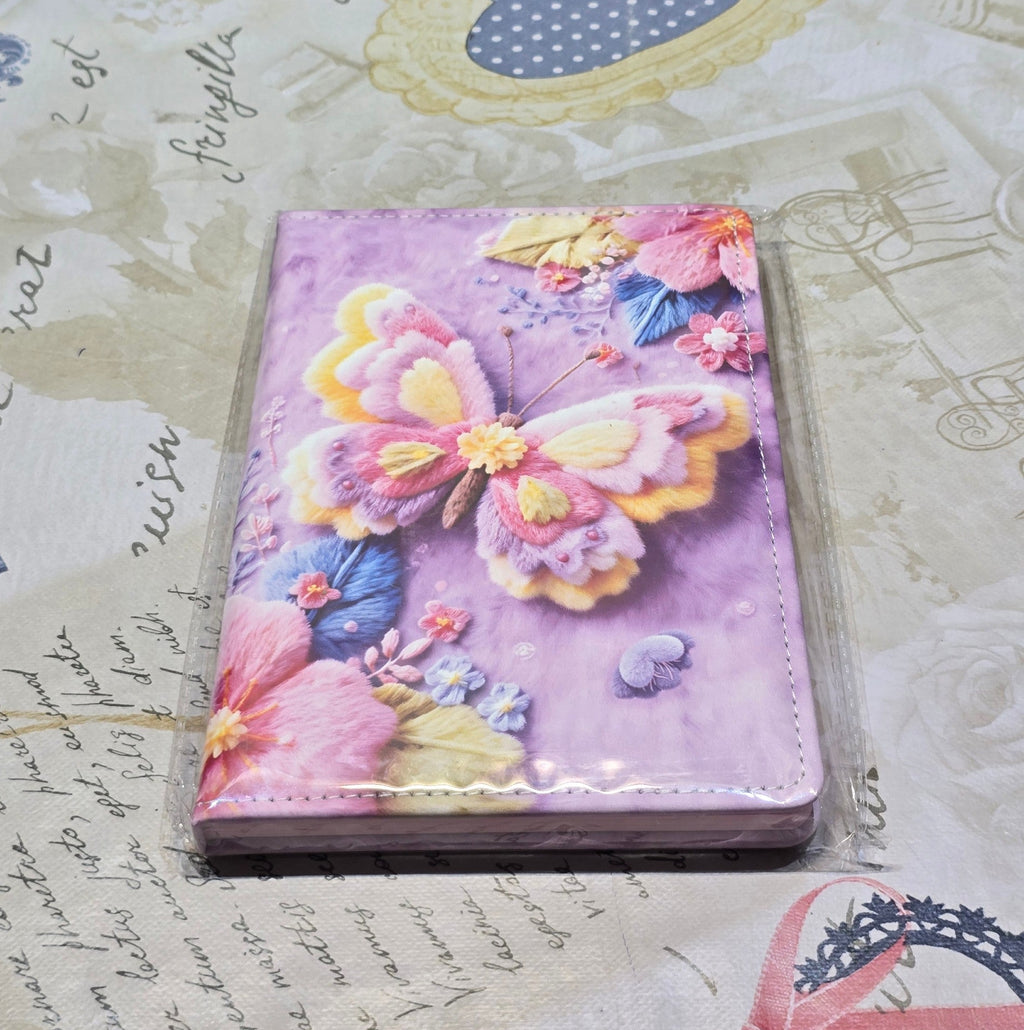 BioCode notebook featuring a vibrant purple cover with tactile 3D-style butterfly and floral embroidery artwork.
