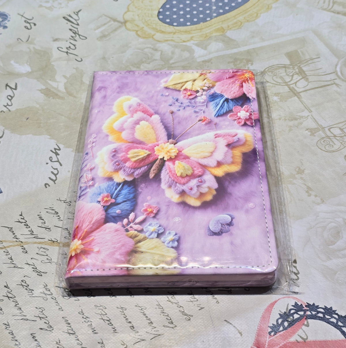 BioCode notebook featuring a vibrant purple cover with tactile 3D-style butterfly and floral embroidery artwork.