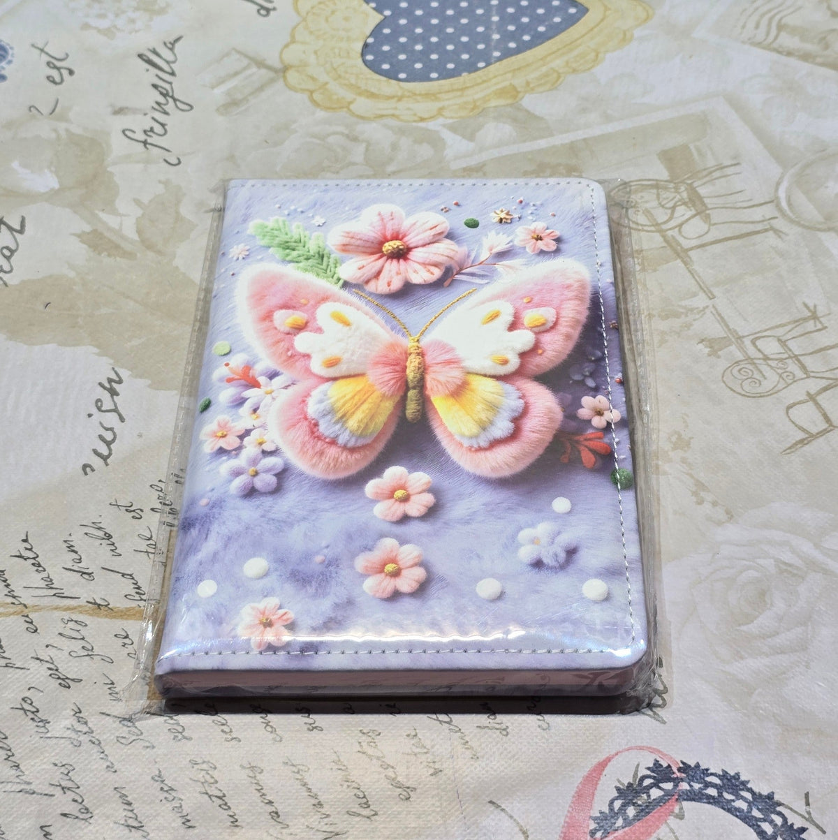 BioCode notebook featuring a textured 3D butterfly design with pastel floral accents on a soft purple background