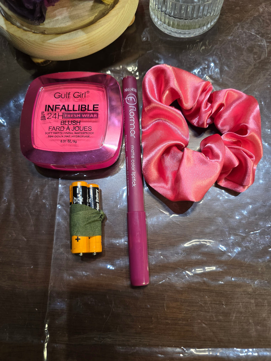BioCode gift set featuring a pink blush compact, matte lipstick, and a satin scrunchie with two AA batteries.