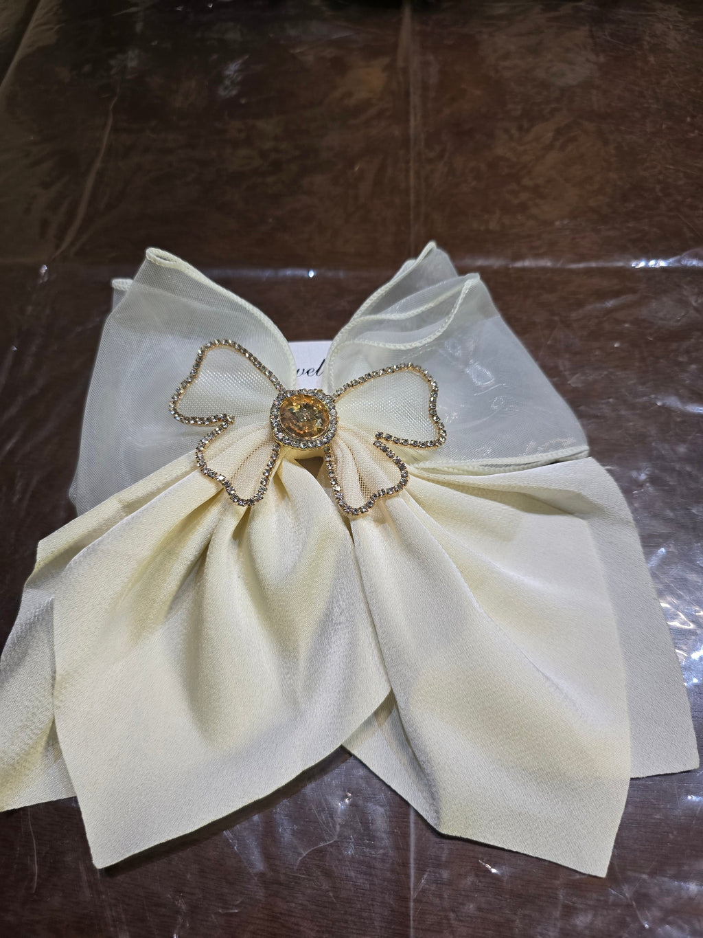 BioCode cream organza hair bow featuring a central rhinestone-encrusted decorative accent for a feminine look