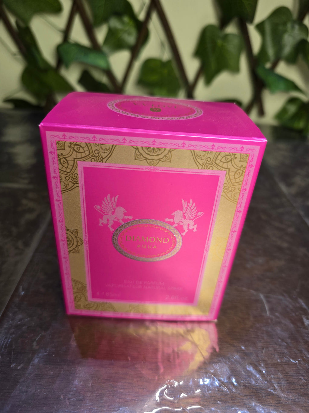 BioCode Diamond Aqua Eau de Parfum in a vibrant pink and gold rectangular box with ornate winged creature motifs.