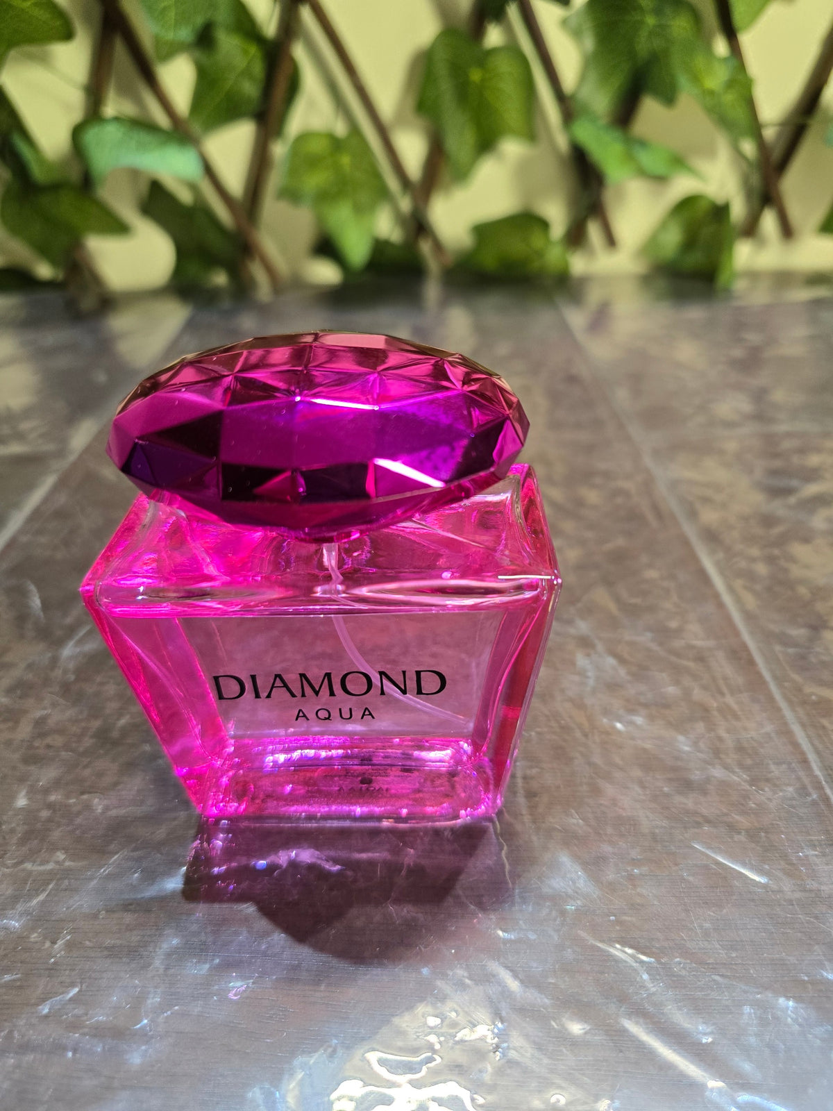 BioCode Diamond Aqua Eau de Parfum in a vibrant pink jewel-toned glass bottle with a faceted cap