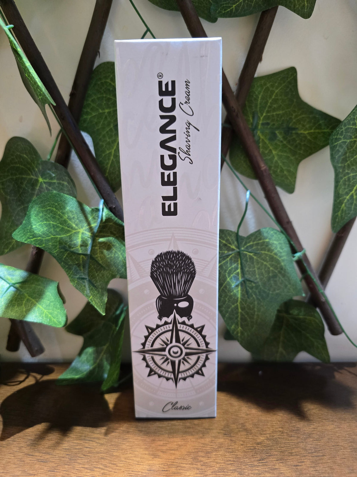 BioCode Elegance Classic shaving cream tube featuring a compass and shaving brush graphic against a leafy background