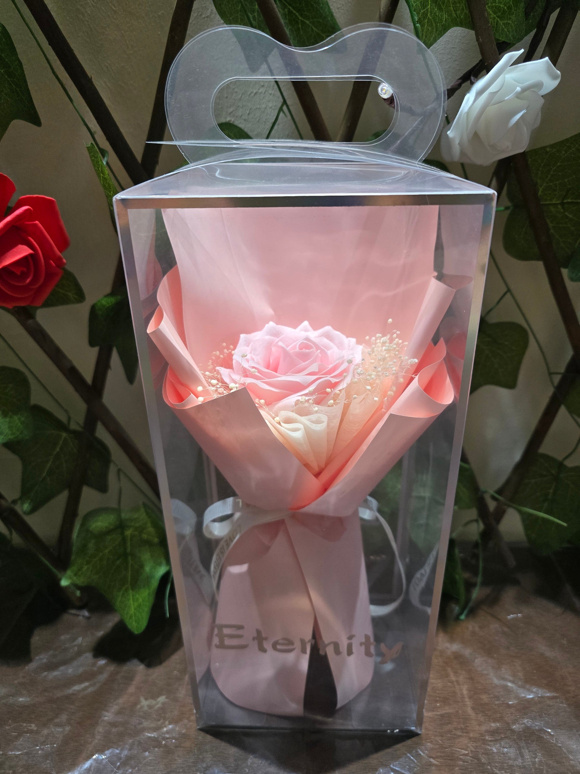 BioCode Eternity single pink artificial rose bouquet in a clear display gift box with ribbon and baby's breath