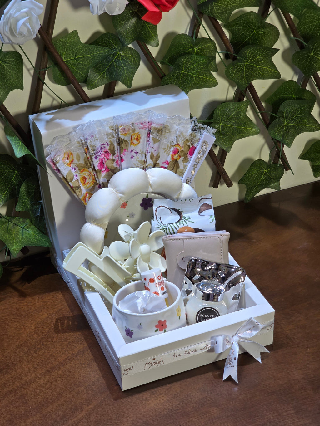 BioCode floral gift set in a white keepsake box featuring a mug, headband, folding fan, and assorted accessories.