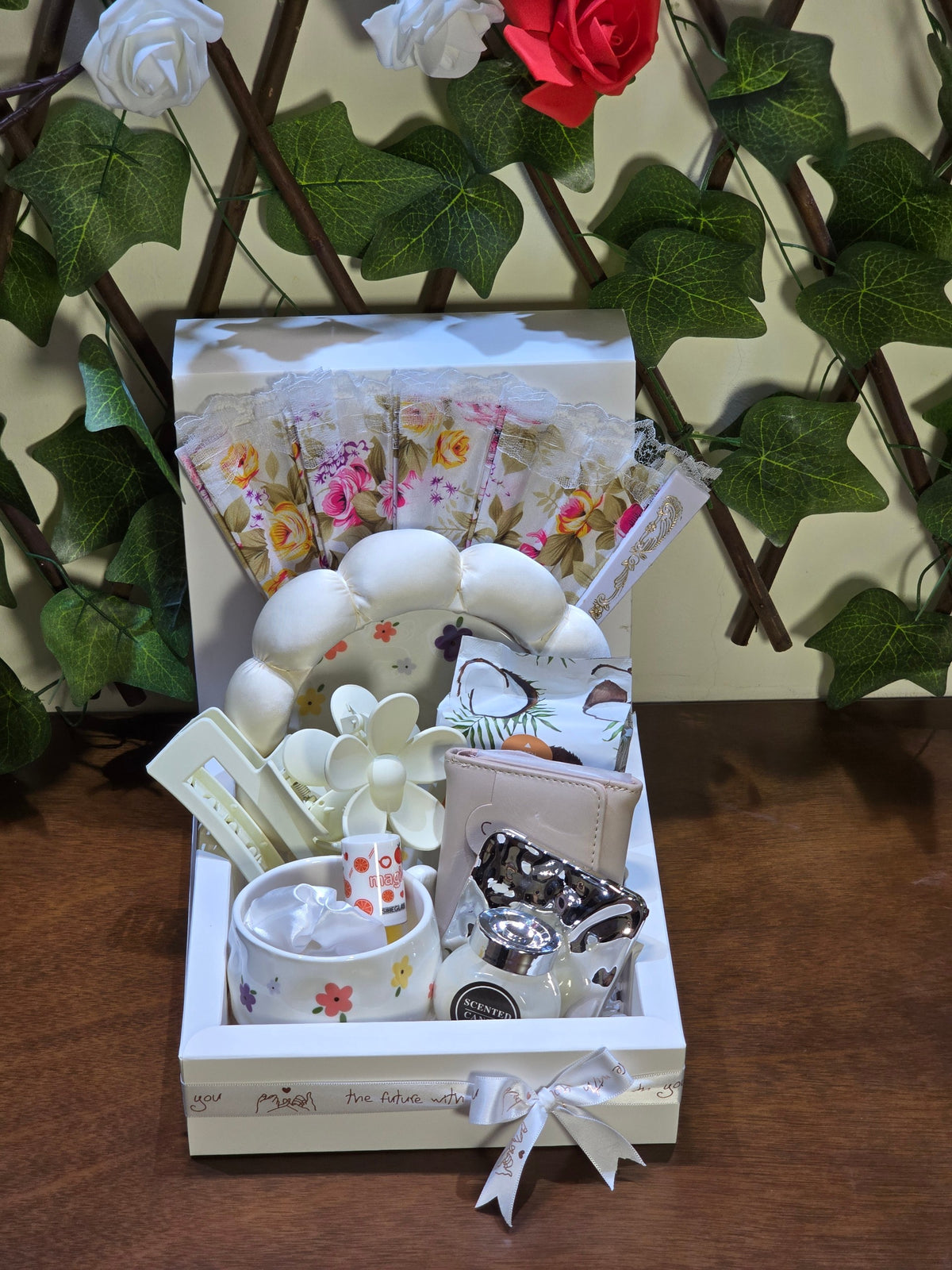 BioCode floral gift set in a white keepsake box featuring a mug, headband, fan, and accessories with floral patterns.