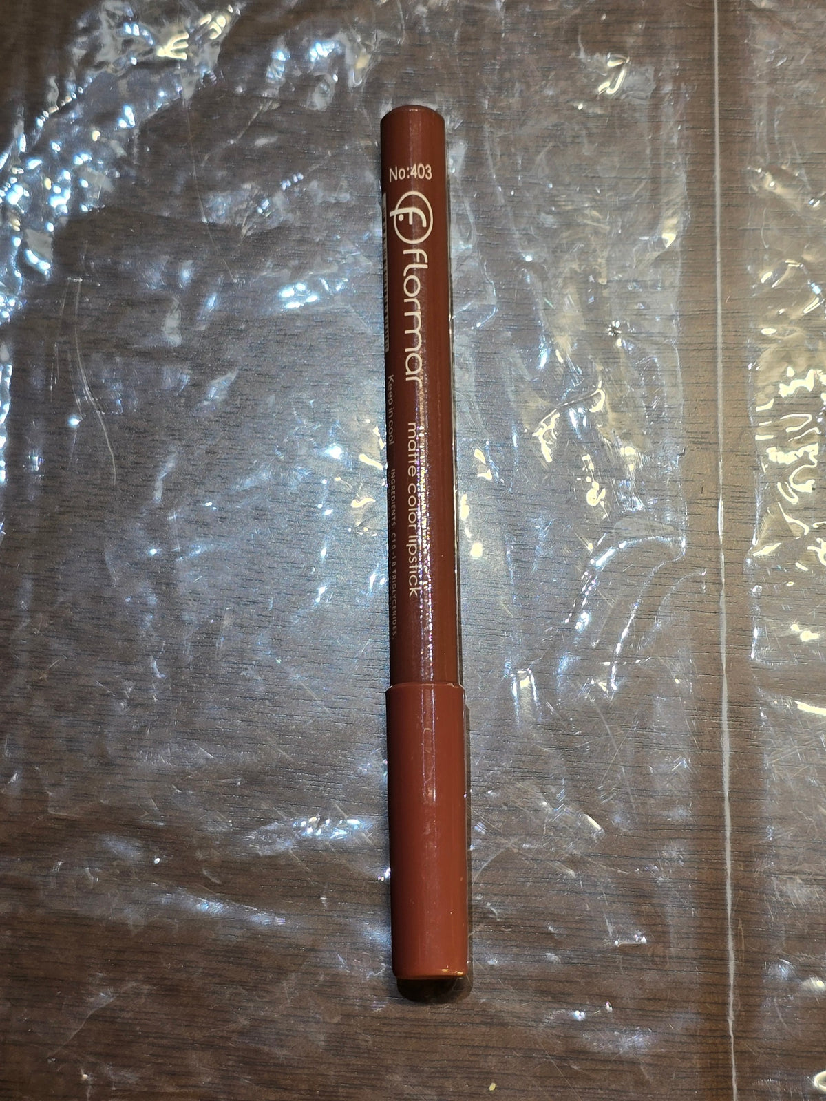 BioCode Flormar matte lipstick pencil in a warm brown shade, featuring a slim design and clear white branding.