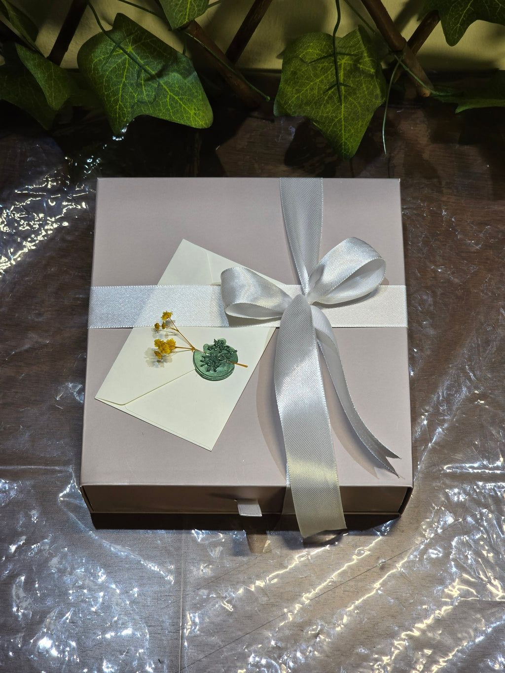 BioCode Fruit Crush beauty gift set in a light pink box with a white satin ribbon, wax-sealed note, and dried flowers