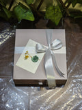 BioCode Fruit Crush beauty gift set in a light pink box with a white satin ribbon, wax-sealed note, and dried flowers