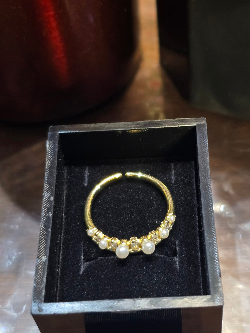 BioCode gold-toned ring with pearls and sparkling stones inside a black velvet gift box