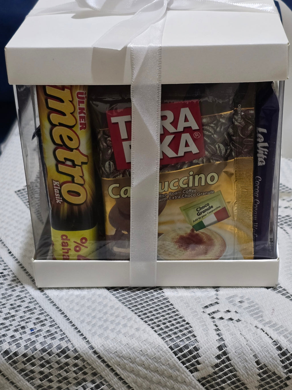 BioCode Happiness Box gift set featuring assorted chocolates, wafers, and cappuccino sachets in a white ribboned box