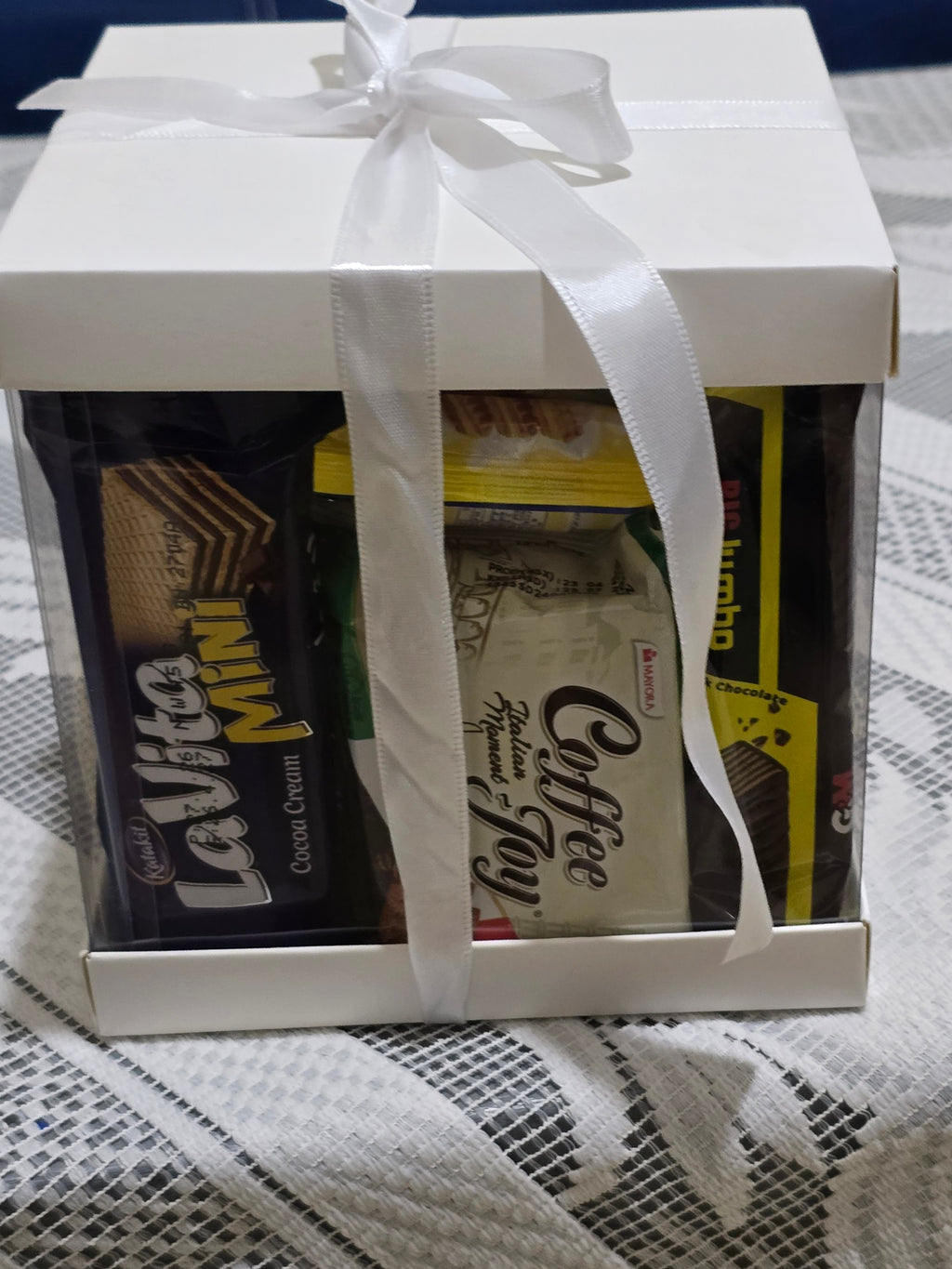 BioCode Happiness Box gift set featuring assorted chocolates and coffee treats in a white box with a white ribbon.