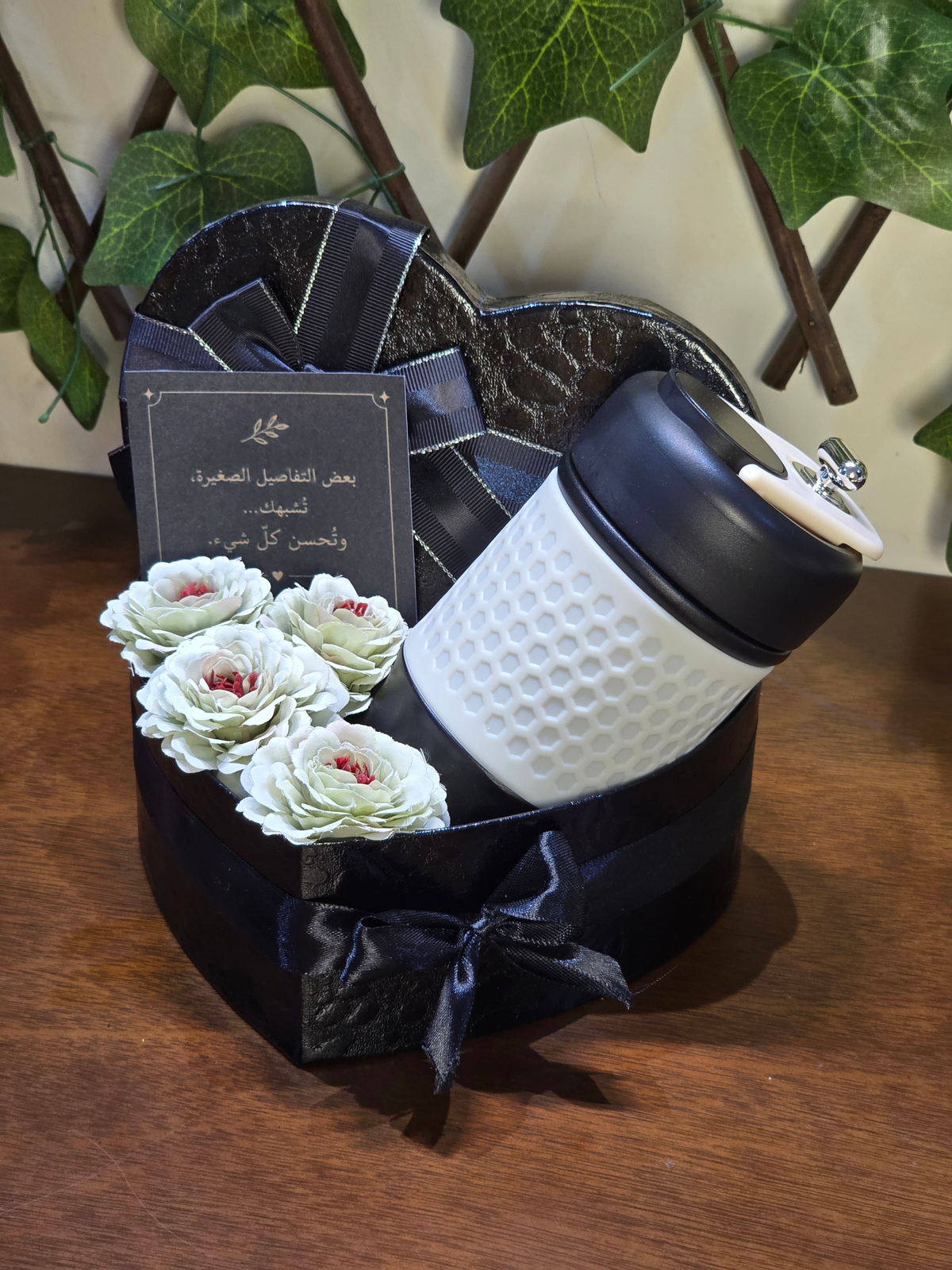 BioCode heart-shaped black gift box containing a white honeycomb-textured thermal mug, artificial flowers, and a card.