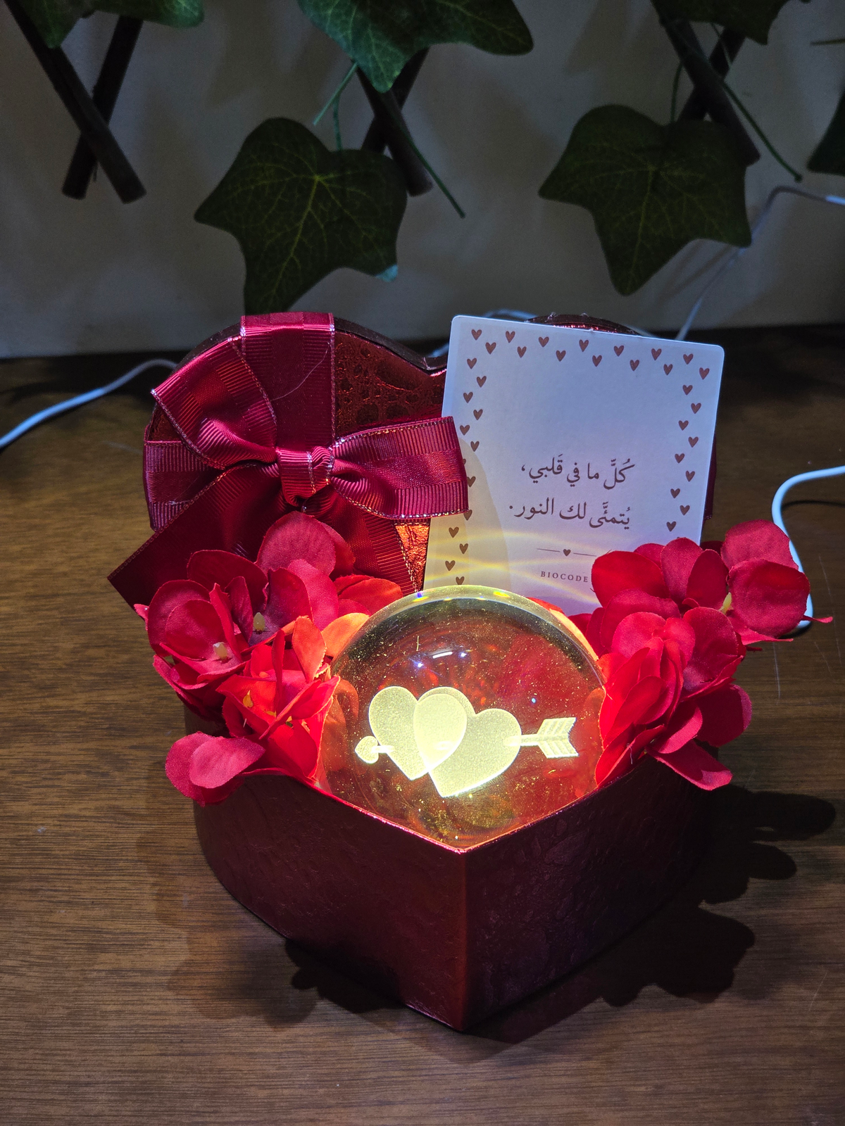 BioCode romantic heart-shaped gift set with an LED crystal ball, red flowers, and a greeting card in a heart box.