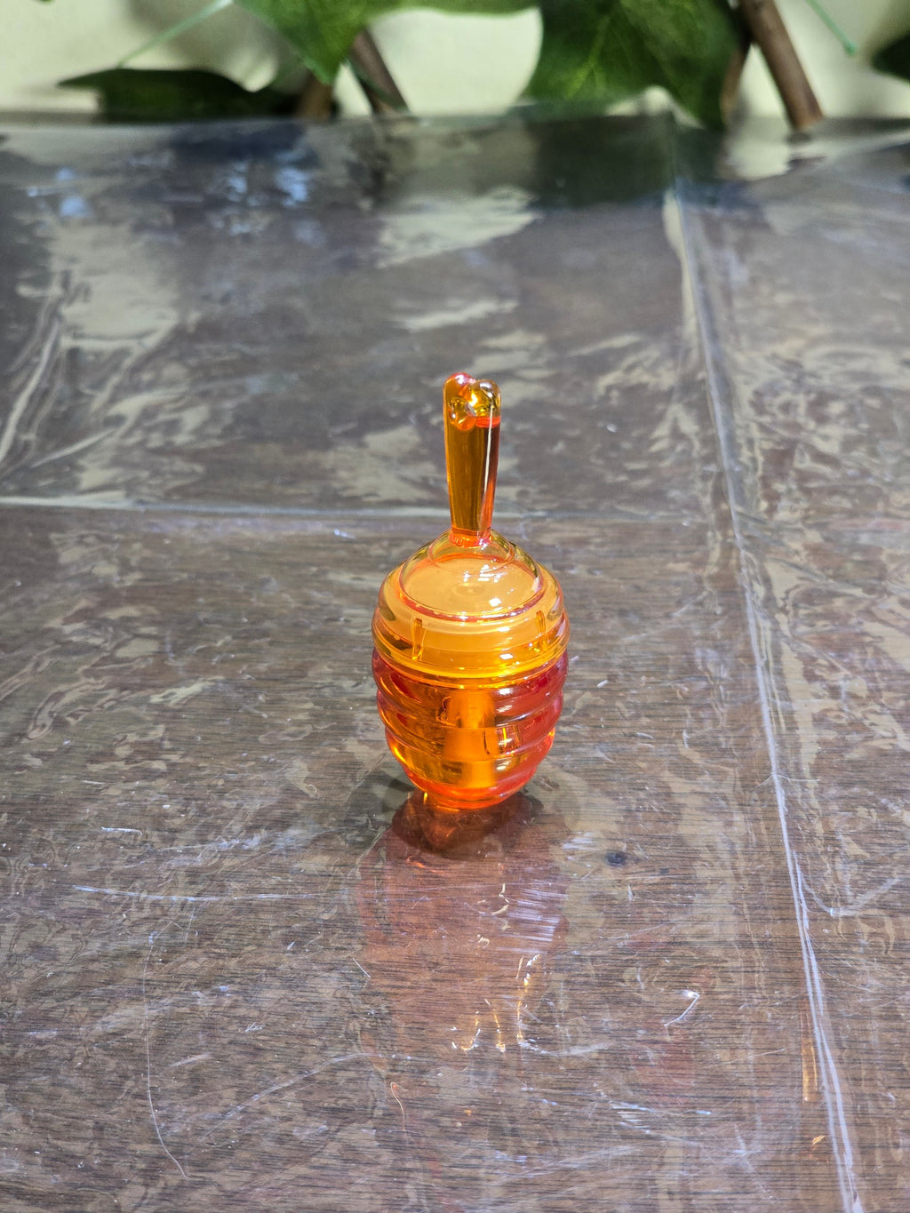 BioCode honey-pot style lip balm container in translucent orange plastic from the Fruit Crush beauty gift set