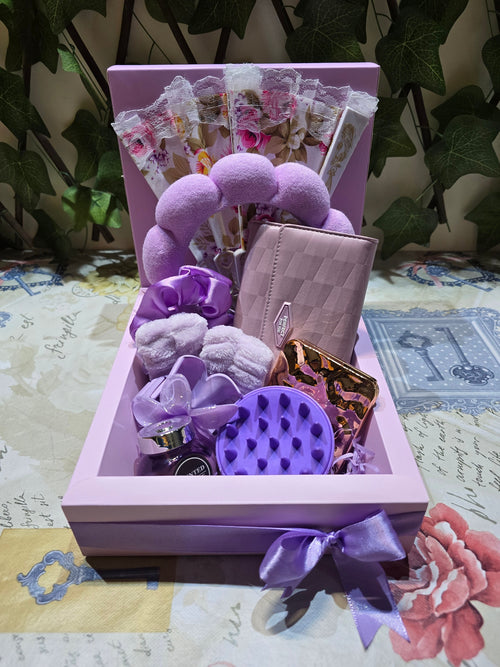 BioCode lilac self-care gift set featuring a headband, wrist cuffs, scalp massager, mirror, wallet, and lace fan.