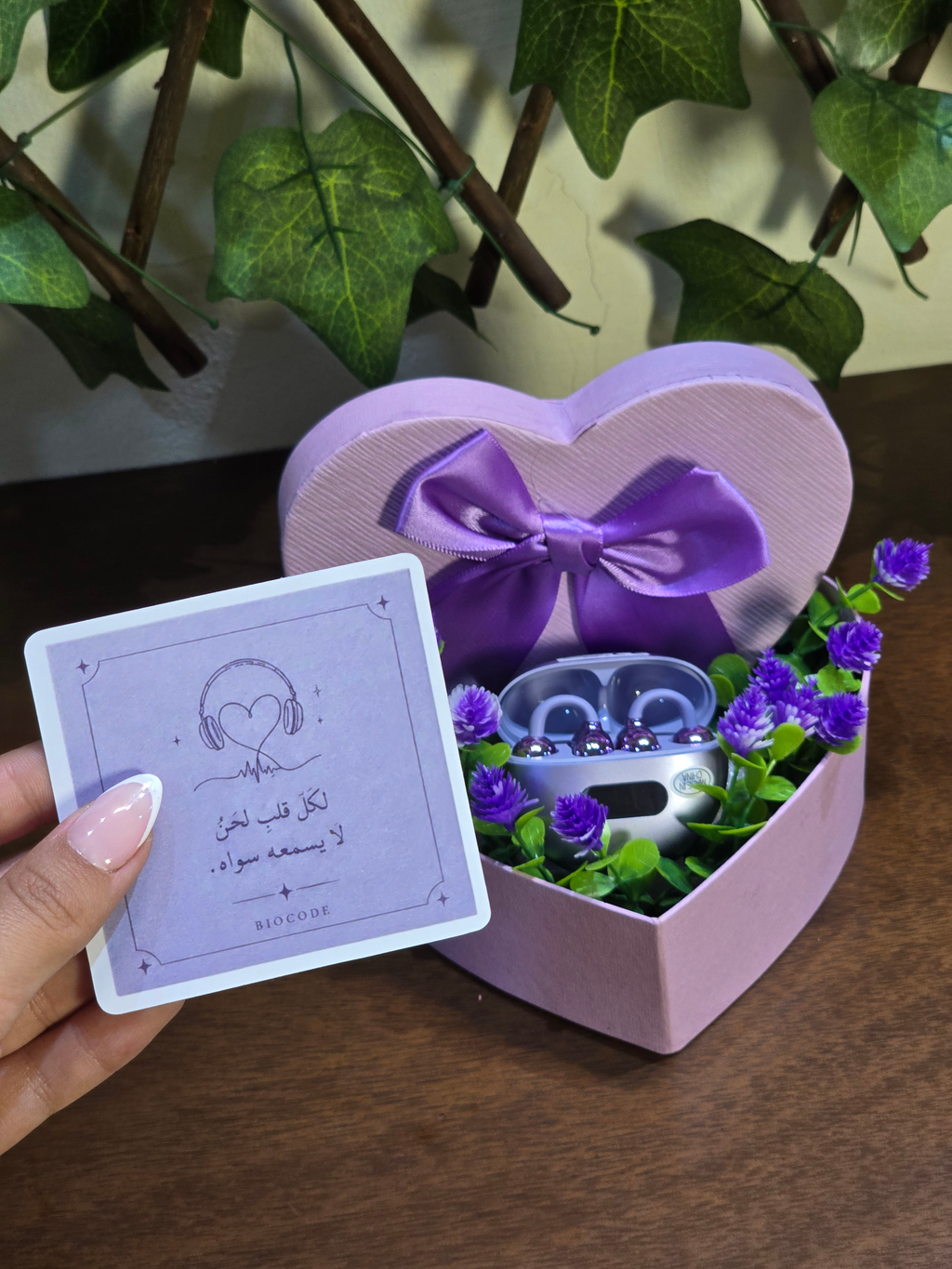 BioCode lilac wireless earbuds in a heart-shaped gift box with a matching card featuring Arabic text and headphones