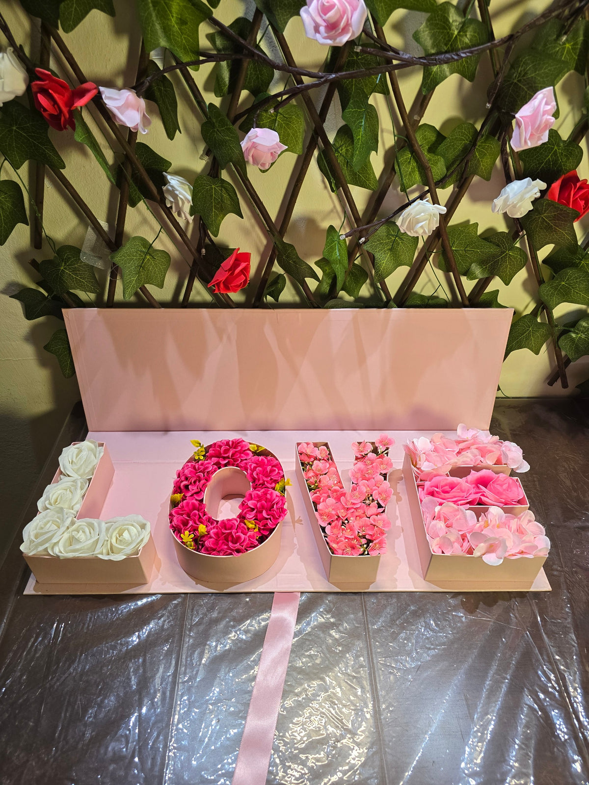 BioCode LOVE floral gift box with artificial white, pink, and blush flowers in a pastel pink presentation box
