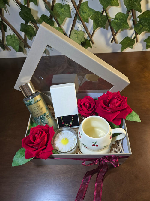 BioCode luxury gift box featuring Victoria's Secret fragrance, cherry mug, jewellery, red roses, and daisy candle.