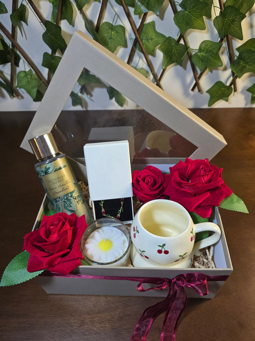 BioCode luxury gift box featuring Victoria's Secret fragrance, cherry mug, jewellery, red roses, and daisy candle.