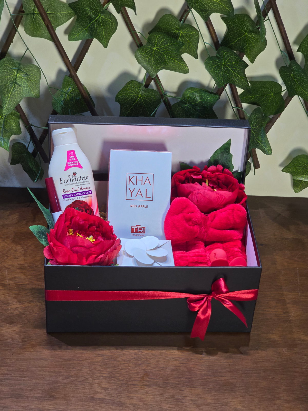 BioCode luxury pampering gift set in a black box with red ribbon, featuring Khayal perfume, Enchanteur lotion, and accessories.