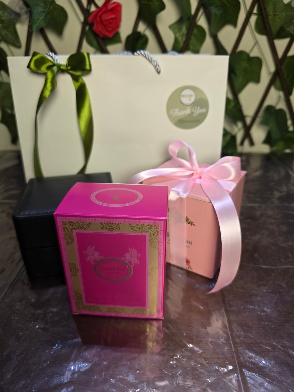 BioCode luxury gift set featuring Diamond Aqua perfume, jewellery boxes, and a gift bag with a green ribbon