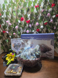 BioCode men's grooming gift hamper featuring a memory foam pillow, personal care items, and a decorative floral display