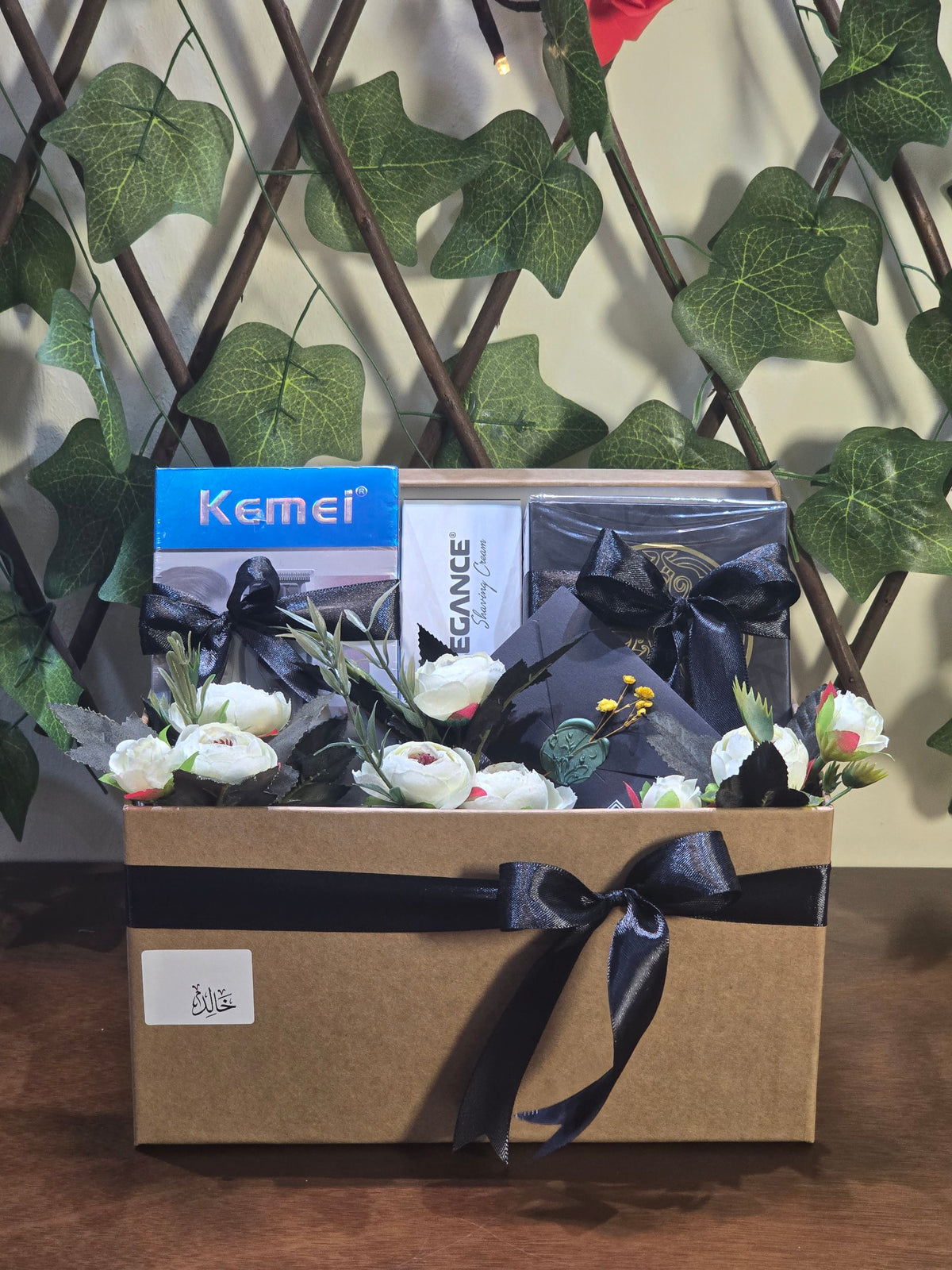 BioCode men's grooming gift set featuring Kemei trimmer, Elegance shaving cream, and fragrance in a decorated box.