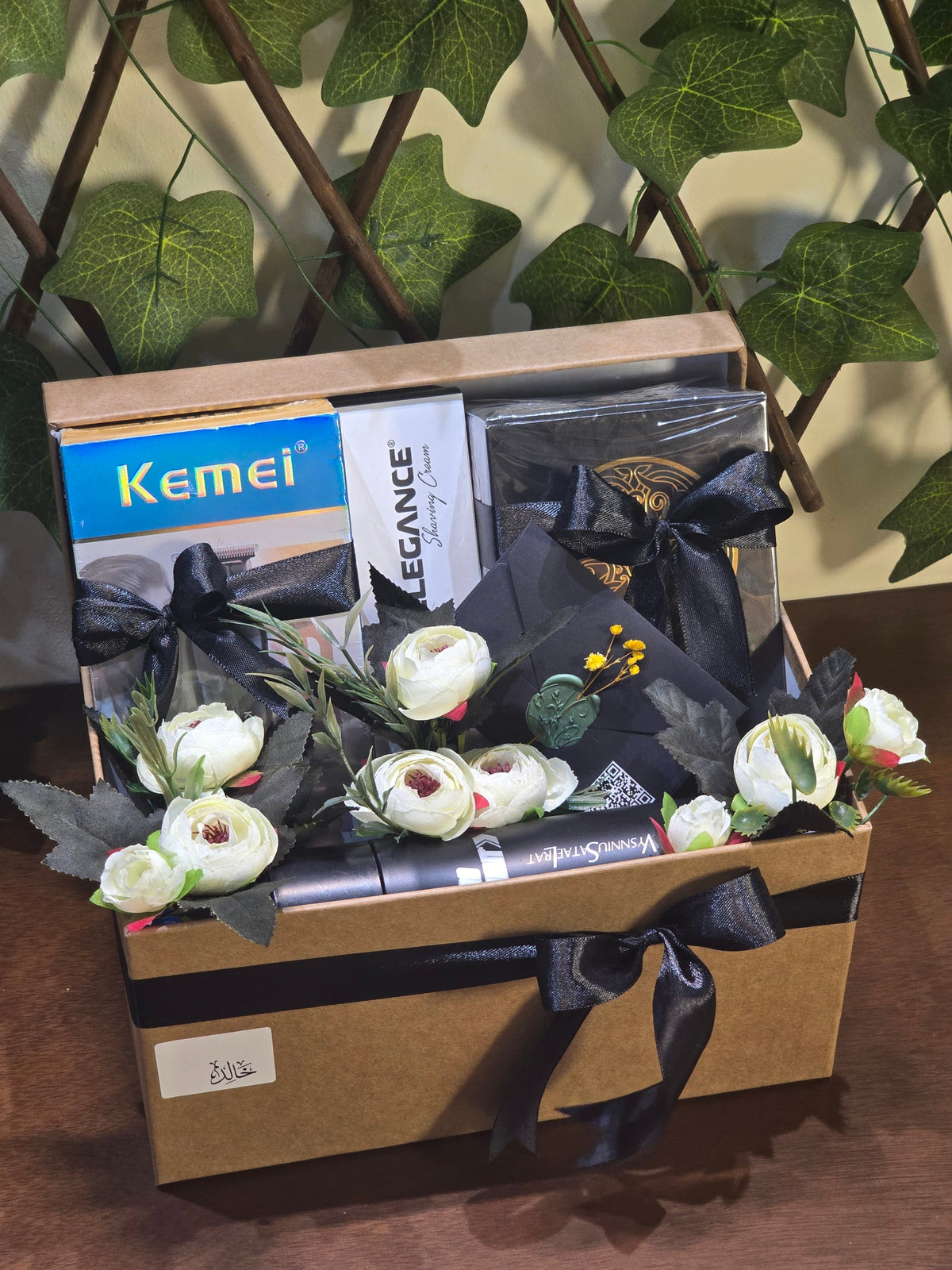 BioCode men's grooming gift set featuring a Kemei trimmer, Elegance shaving cream, and Gissaty perfume in a box.