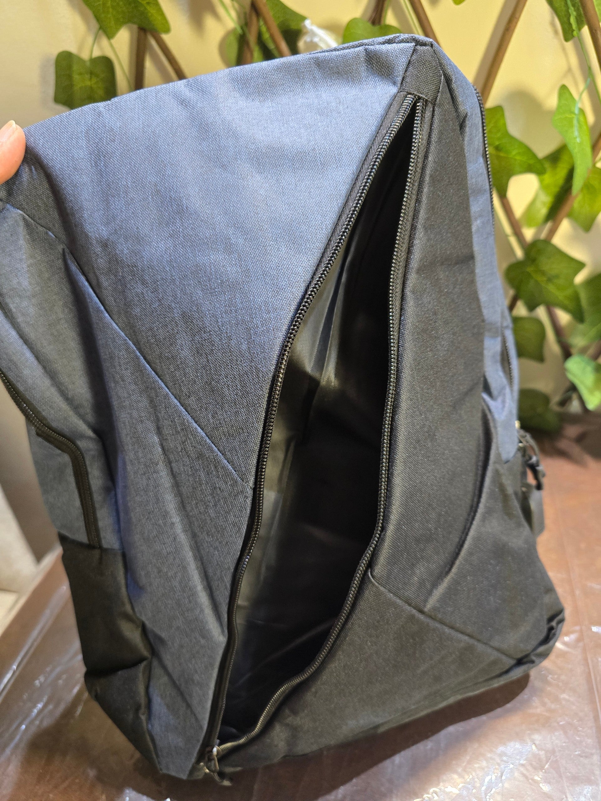 BioCode water-resistant backpack in navy blue with a large diagonal zippered compartment and minimalist design