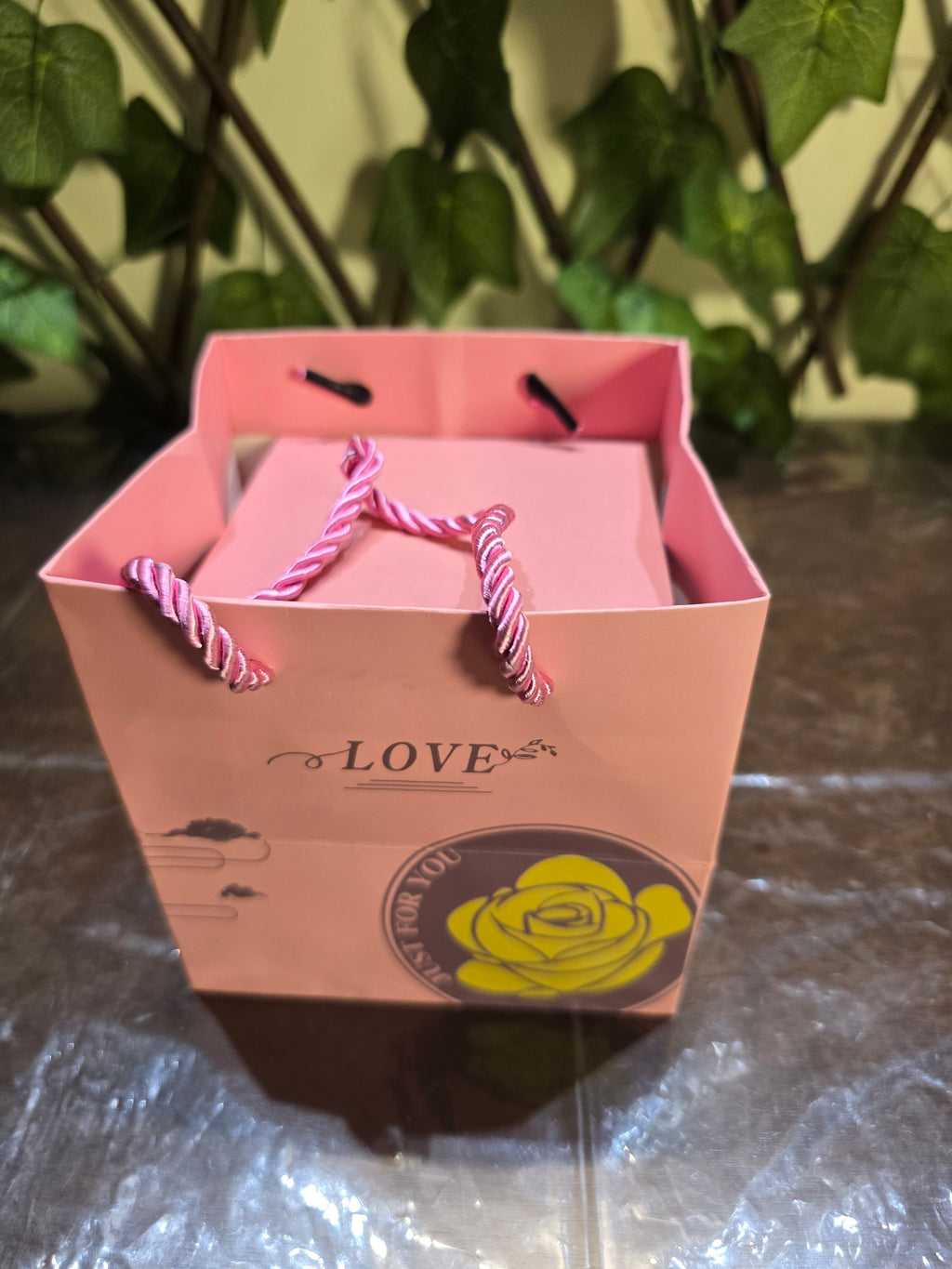 BioCode pink gift bag with rope handles featuring a yellow rose graphic and Love text for a jewellery gift box