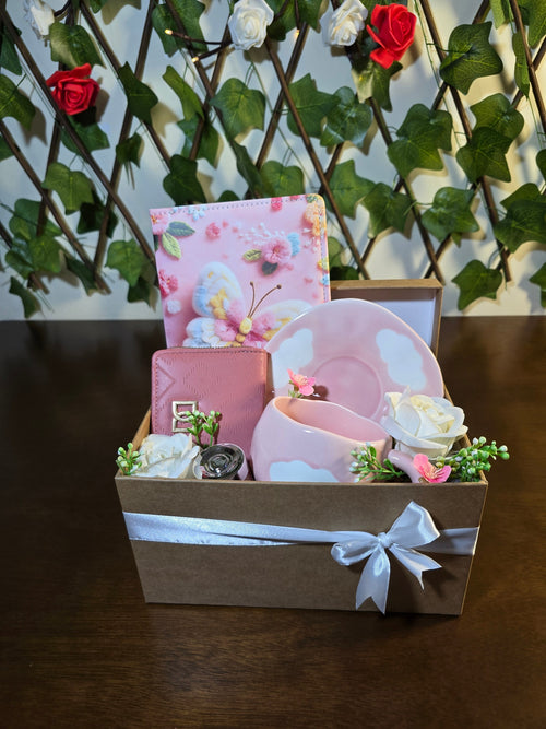 BioCode pink gift set featuring a butterfly notebook, textured wallet, and cloud-themed ceramic mug in a ribboned box.