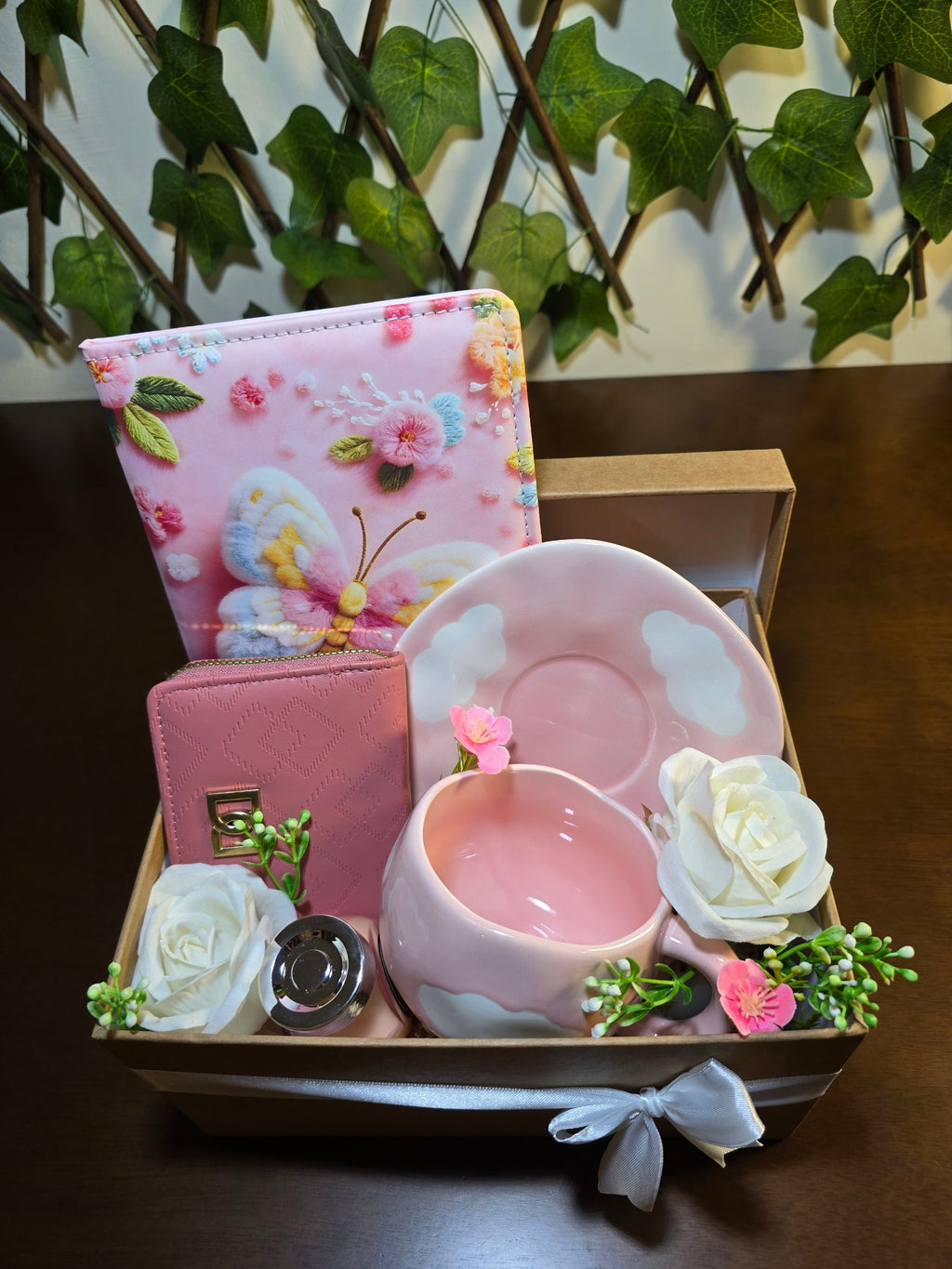 BioCode pink gift set featuring a butterfly notebook, textured wallet, and cloud-themed ceramic mug in a gift box.